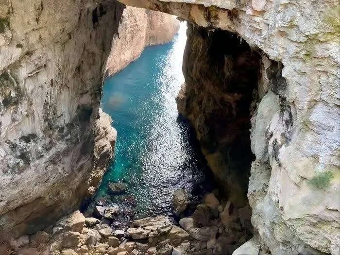 View of the turquoise sea between the cliffs of Montagna Spaccata in Gaeta